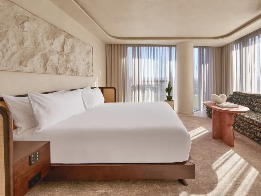 A guest room at Mondrian Gold Coast with ocean light through sheer curtains